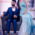 fashion photography nearby, ambience mall, Gurugram, man wearing blue formal suit, girl in cyan long dress, sitting on sofa, posing, anubhavshaphotography