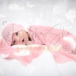 newborn infant photography, indoor home, props, anubhavshaphotography, wrapped in pink cloth, following feathers