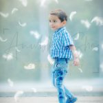 1 year poser baby toddler photography, garden, props, boy in check shirt, denim, following feather, posing, anubhavshaphotography