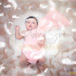 newborn infant photography, indoor home, props, anubhavshaphotography, pink wrapper in bucket, following feathers