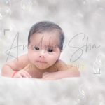 newborn infant photography, indoor home, props, anubhavshaphotography, pink wrapper, baby raising head, posing