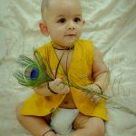 1 year traditional baby photoshoot indoor home, yellow krishna janmashtami theme props, anubhavshaphotography