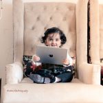 1 year baby photoshoot indoor home royal traditional dress holding apple iPad study theme