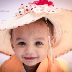 1 years poser baby toddler photography, garden, props, boy in yellow shirt, hat, face closeup, posing, anubhavshaphotography