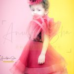 2 years baby girl toddler photoshoot indoor home colorful background red frill bubble dress head band
