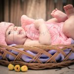 newborn infant photography, indoor home, props, anubhavshaphotography, smiling baby wrapped pink in bucket