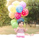 Pink floral cake smash theme baby photoshoot outdoor garden colorful balloons pink girl dress props