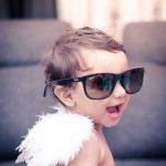 1 year sitting baby photoshoot indoor home wings angels theme rayban glasses