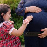 maternity pregnancy photography, outdoor, 6 years daughter using stethoscope with pregnant mother, happy, love, posing, care, anubhavshaphotography