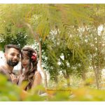pre wedding photography, man wearing brown t-shirt with denim, girl in peach dress, flowers hair band, garden, posing, anubhavshaphotography