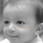 1 year sitting baby photoshoot indoor home face closeup smile black&white