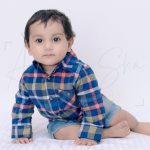 1 year sitting baby photoshoot indoor home blue red check formal shirt with denim shorts