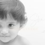 1 year sitting baby photoshoot indoor home face closeup smiling toddler black&white
