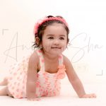 1 year poser baby photography, home, props, girl in orange polka dots dress, flowers tiara, posing, anubhavshaphotography
