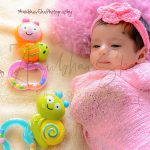 newborn infant photography, indoor home, props, anubhavshaphotography, wrapped in pink cloth, flower tiara, colorful toys