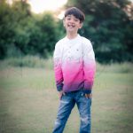 7 years poser baby photography, garden, props, boy in pink white t-shirt and denim, laughing, anubhavshaphotography