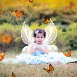 1 year sitting baby girl photoshoot outdoor garden blue frill tiara wings butterflies flowers trees