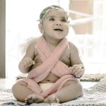 1 year sitter baby girl photoshoot home wearing tiara wings pink cotton wrap angel theme