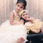sibling photography, indoor home, Delhi, 1 year girl, 6 years girl, yellow frill frocks, tiara, posing, anubhavshaphotography