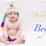 1 year sitting baby photoshoot indoor home colorful wollen cap diaper white background
