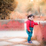 1 year poser baby photography, garden, props, boy in red sweat shirt and denim galice, smiling, anubhavshaphotography