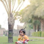 6 months baby traditional photoshoot outdoor garden, colorful krishna janmashtami theme props, anubhavshaphotography