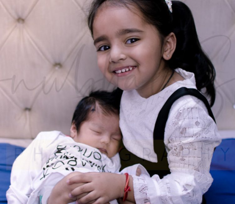sibling photoshoot indoor Delhi, newborn boy, 2 years girl in black white dress, posing, anubhavshaphotography
