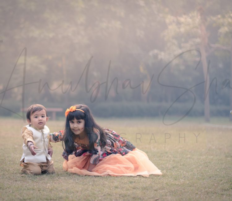 sibling photoshoot outdoor Delhi, 1 year boy in formals, 6 years girl in orange floral dress, posing, anubhavshaphotography