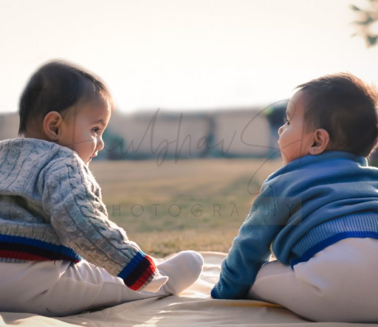 1 year twins baby photography, sitting in garden, props, wearing colourful sweaters, enjoying, anubhavshaphotography