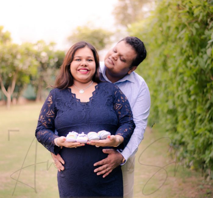 maternity pregnancy photography, outdoor, pregnant wife posing with husband, baby shoes, love, posing, care, anubhavshaphotography