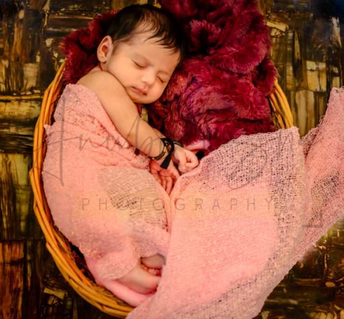 newborn infant photography, indoor home, props, anubhavshaphotography, pink wrapper, sleeping girl in basket